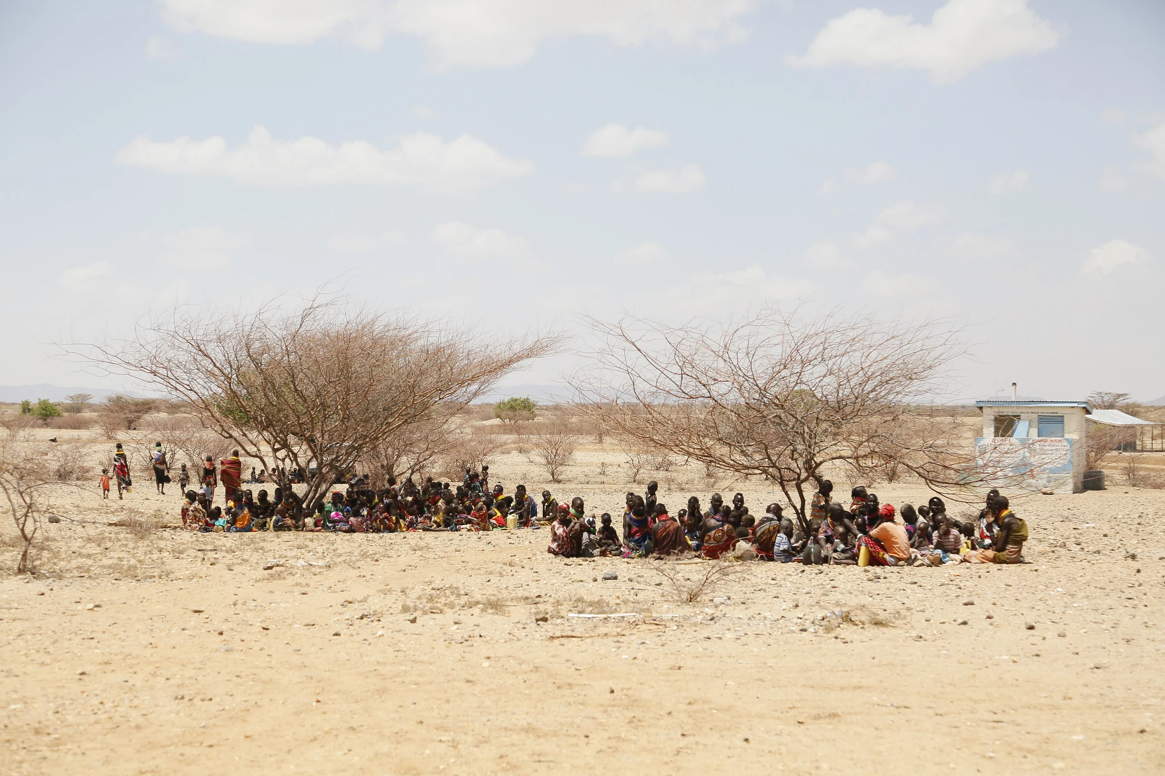 Women and children shelter from the sun at a health clinic in Turkana, 2017
