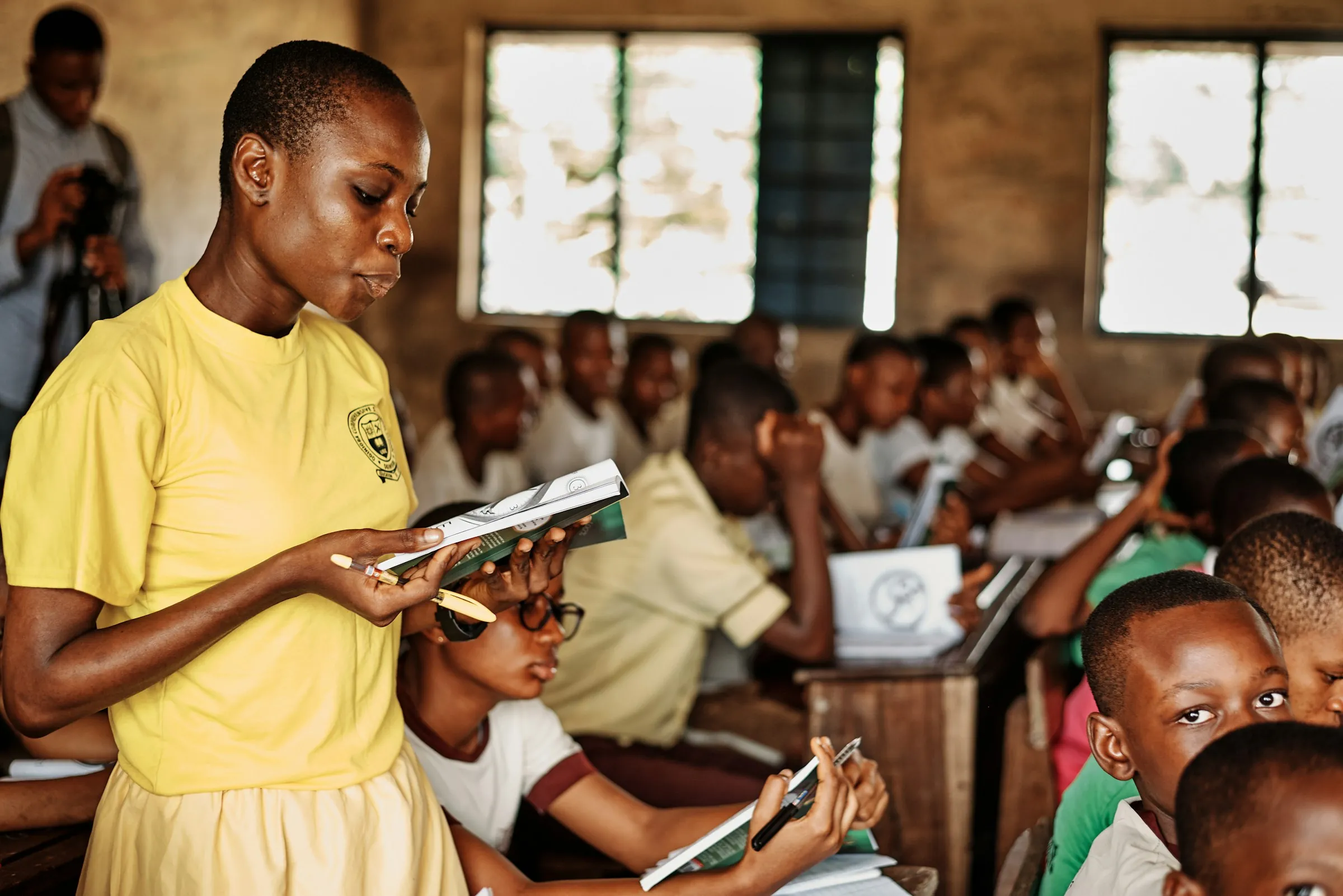 A teacher reading with students in a classroom