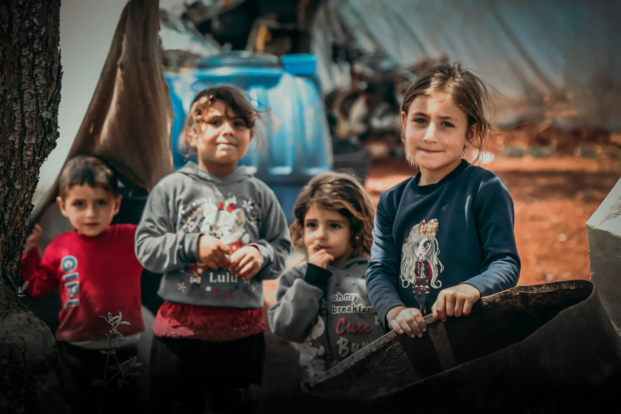 A group of children standing together outside